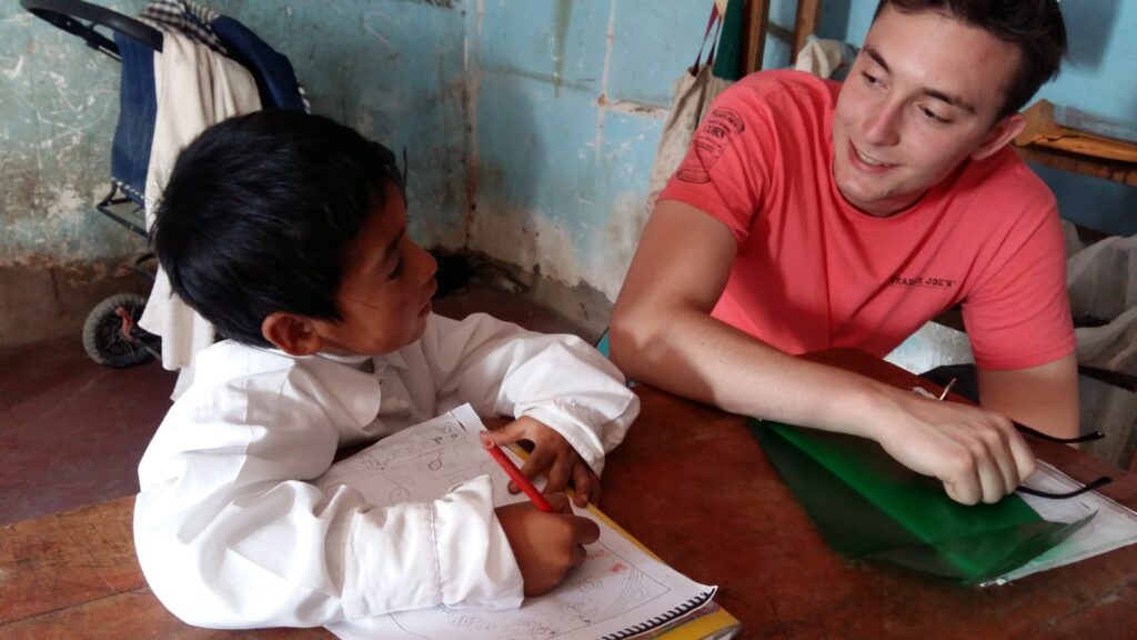 A Volunteer helping a children in Peru